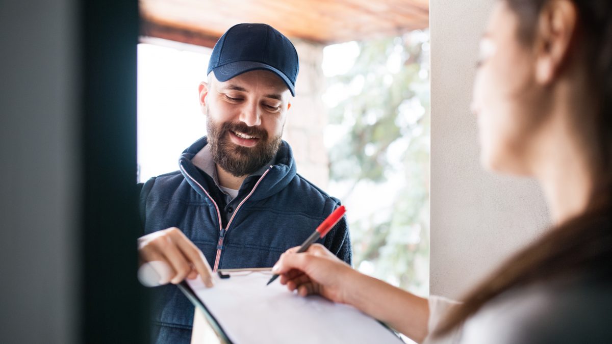 Client signing document at door